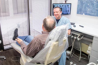 Dr. Alex Martin discussing how dental crowns can help restore a patient's smile