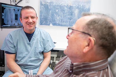 Dr. Alex Martin discussing a dental plan with his patient