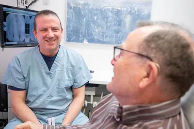 Dr. Alex Martin discussing a dental plan with his patient