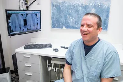 Dr. Alex Martin reviewing a patient's dental x-rays