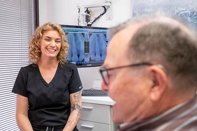 patient discussing restorative dentistry options with the dentist at Alex Martin, DDS